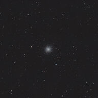 Messier 13 as a bright globular cluster surrounded by stars